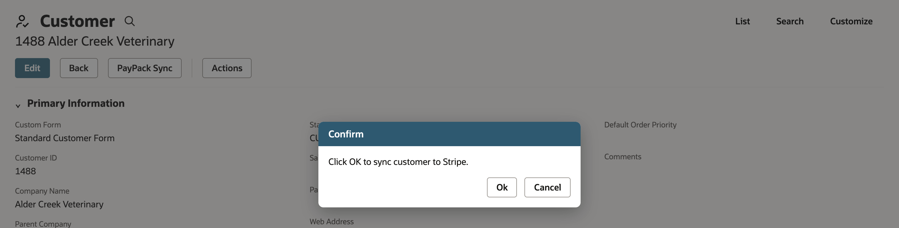 Confirm dialog over the saved customer reading Click OK to sync customer to Stripe, with Ok and Cancel buttons and a red arrow pointing at Ok.